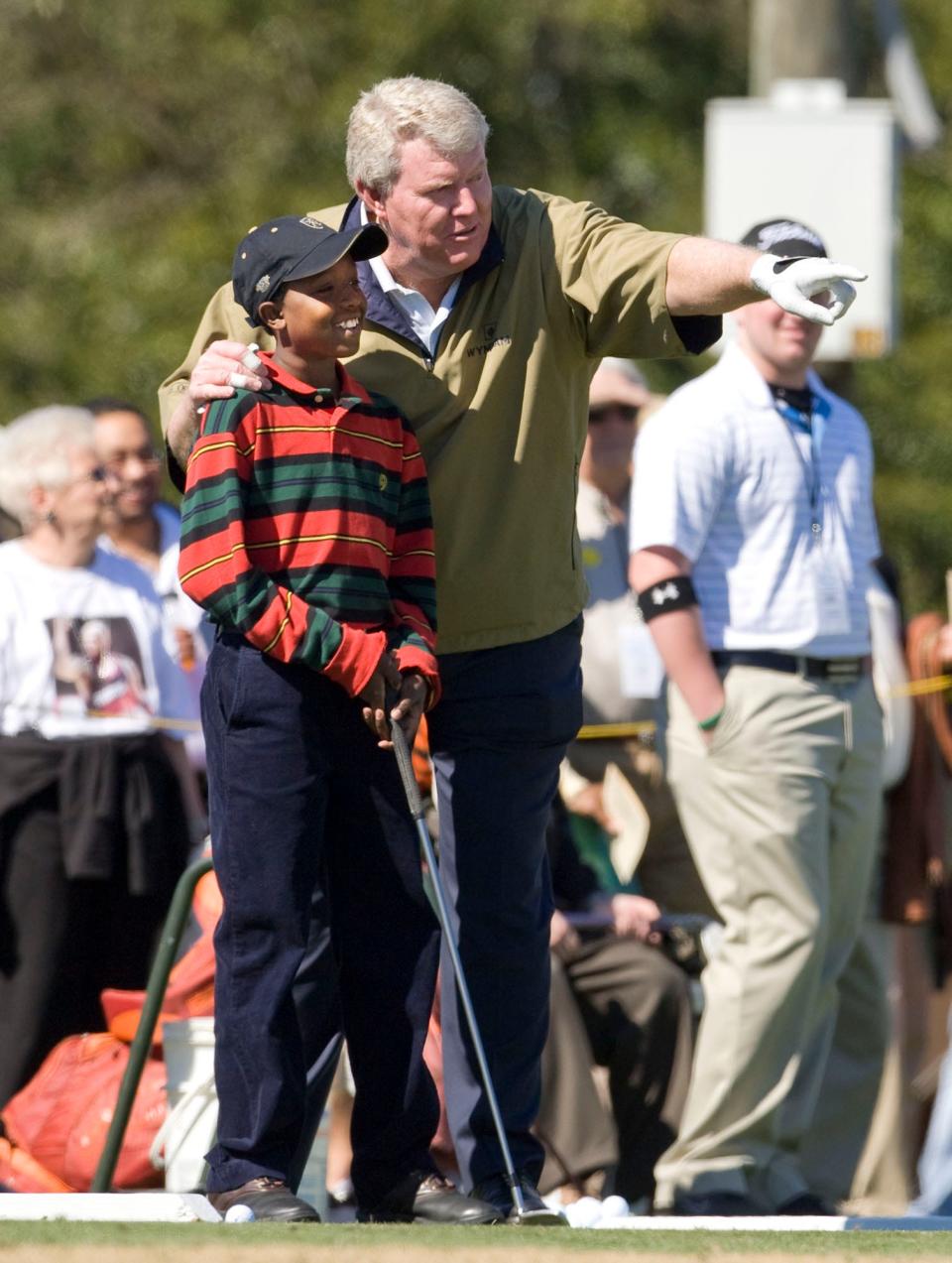 Andy Bean points down range with Tamarrick Wright, 12, of Lakeland during the Barkley, Bean, Bryant & Friends event at the YMCA's First Tee in Lakeland in 2009.