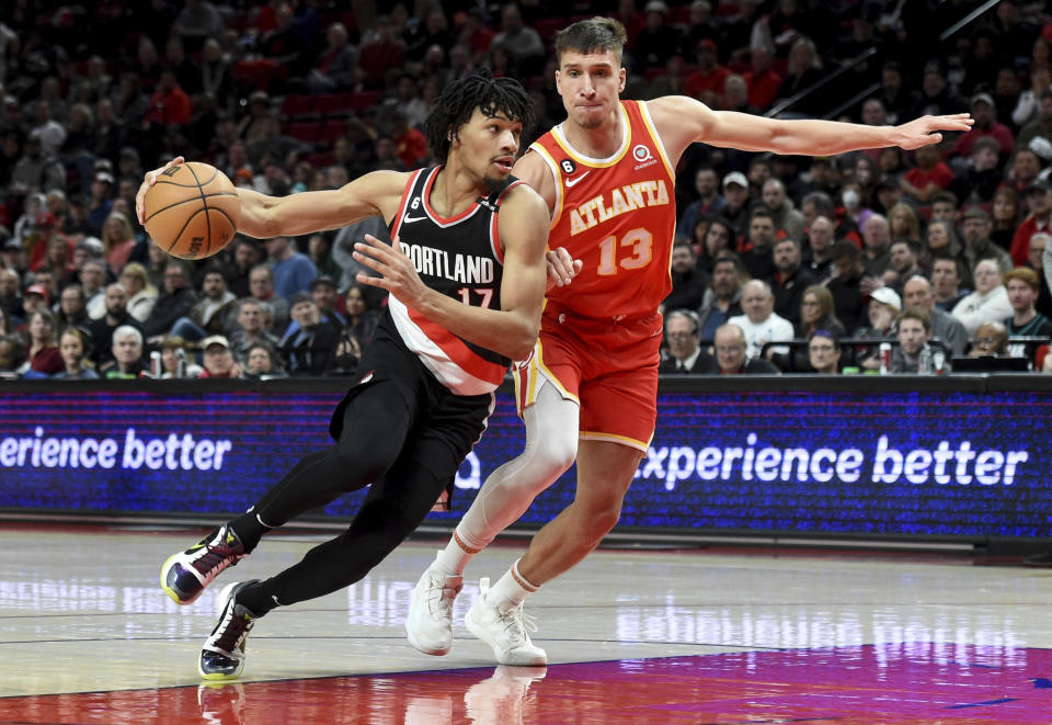 Portland Trail Blazers guard Shaedon Sharpe, left, drives to the basket on Atlanta Hawks guard Bogdan Bogdanovic, right, during the second half of an NBA basketball game in Portland, Ore., Monday, Jan. 30, 2023. The Blazers won 129-125. (AP Photo/Steve Dykes)