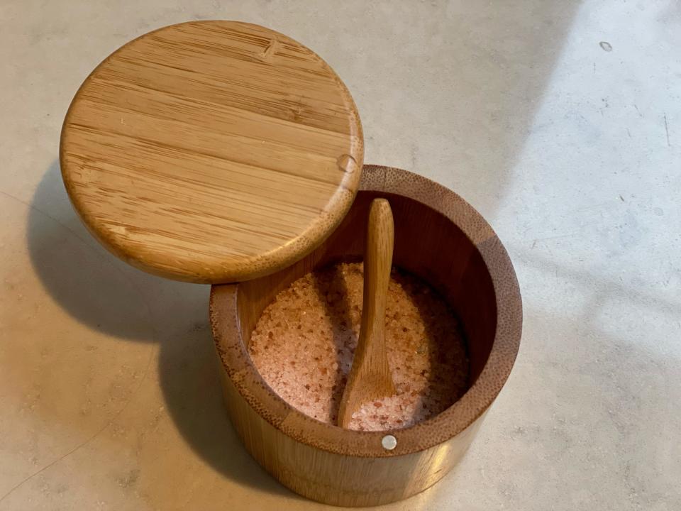 wooden salt cellar filled with pink Himalayan salt