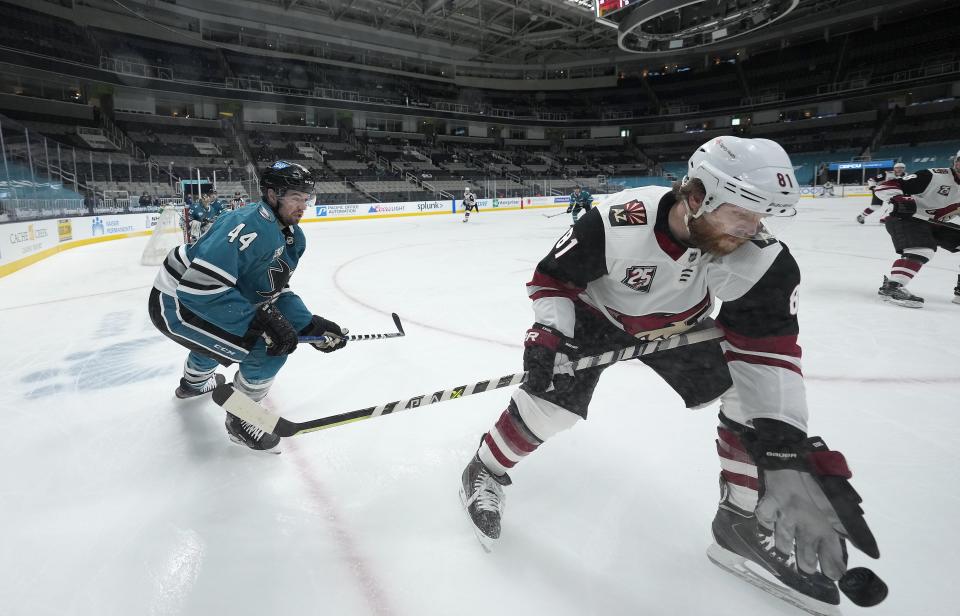 Arizona Coyotes right wing Phil Kessel (81) works for the puck against San Jose Sharks defenseman Marc-Edouard Vlasic (44) during the second period of an NHL hockey game Friday, May 7, 2021, in San Jose, Calif. (AP Photo/Tony Avelar)