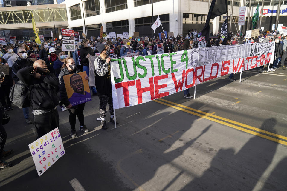 Demonstrators gather outside the Hennepin County Government Center, Monday, March 8, 2021, in Minneapolis where the trial for former Minneapolis police officer Derek Chauvin began with jury selection. Chauvin is charged with murder in the death of George Floyd during an arrest last May in Minneapolis. (AP Photo/Jim Mone)