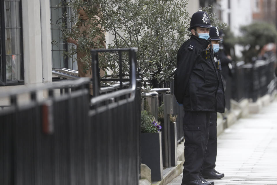 Police officers stand outside King Edward VII's hospital in London, Thursday, Feb. 18, 2021. Buckingham Palace says 99-year-old Prince Philip has been admitted to a London hospital after feeling unwell. The palace said the husband of Queen Elizabeth II was admitted to the private King Edward VII Hospital on Tuesday evening. (AP Photo/Kirsty Wigglesworth)