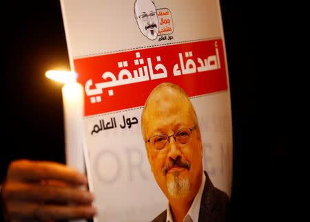 FILE PHOTO: A demonstrator holds a poster with a picture of Saudi journalist Jamal Khashoggi outside the Saudi Arabia consulate in Istanbul, Turkey October 25, 2018. REUTERS/Osman Orsal