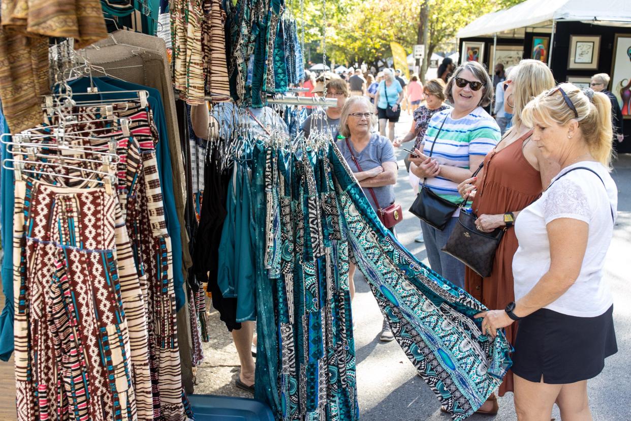 Patrons browse clothing at the Autmn Teneyl vendor booth at the 2021 St. James Court Art Show. Oct. 1, 2021