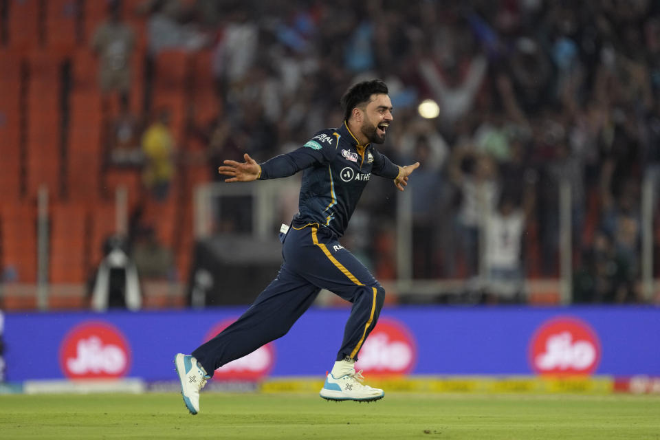 Gujarat Titan's Rashid Khan celebrates the wicket of Kolkata Knight Riders's Shardul Thakur during the Indian Premier League (IPL) match between Gujarat Titans and Kolkata Knight Riders in Ahmedabad, India, Sunday, April 9, 2023. (AP Photo/Ajit Solanki)