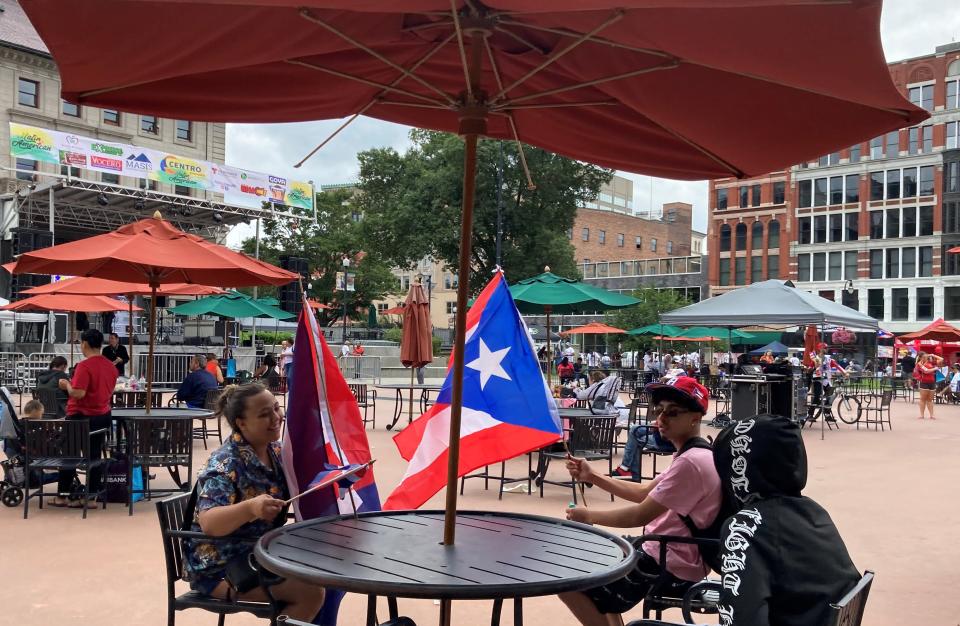 From left, Adriela Benitez, 17, and Nathaniel Hernandez, 18 show off their colors, Cuban for Adriela and Puerto Rican for Nathaniel, Saturday at the Latin American Festival in Worcester.