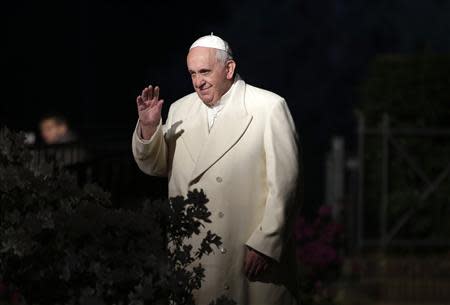 Pope Francis waves as he arrives to lead the Via Crucis (Way of the Cross) procession during Good Friday celebrations in front of the Colosseum in Rome April 18, 2014. REUTERS/Max Rossi