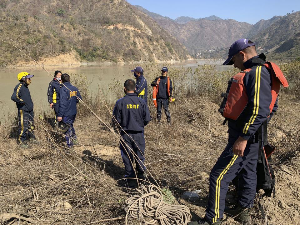 Rescuers prepare to search for bodies in the downstream of Alaknanda River in Rudraprayag, northern state of Uttarakhand, India, Monday, Feb.8, 2021. More than 2,000 members of the military, paramilitary groups and police have been taking part in search-and-rescue operations after part of a Himalayan glacier broke off Sunday and sent a wall of water and debris rushing down the mountain. (AP Photo/Rishabh R. Jain)