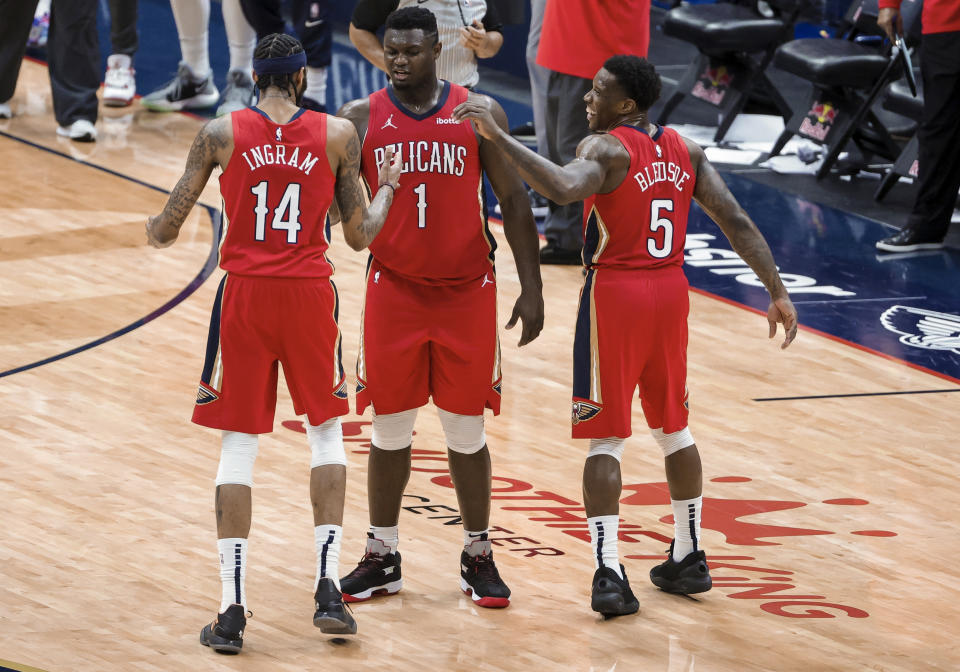 New Orleans Pelicans forward Zion Williamson (1) celebrates with forward Brandon Ingram (14) and guard Eric Bledsoe (5) following the team's win over the Memphis Grizzlies in an NBA basketball game in New Orleans, Saturday, Feb. 6, 2021. (AP Photo/Derick Hingle)