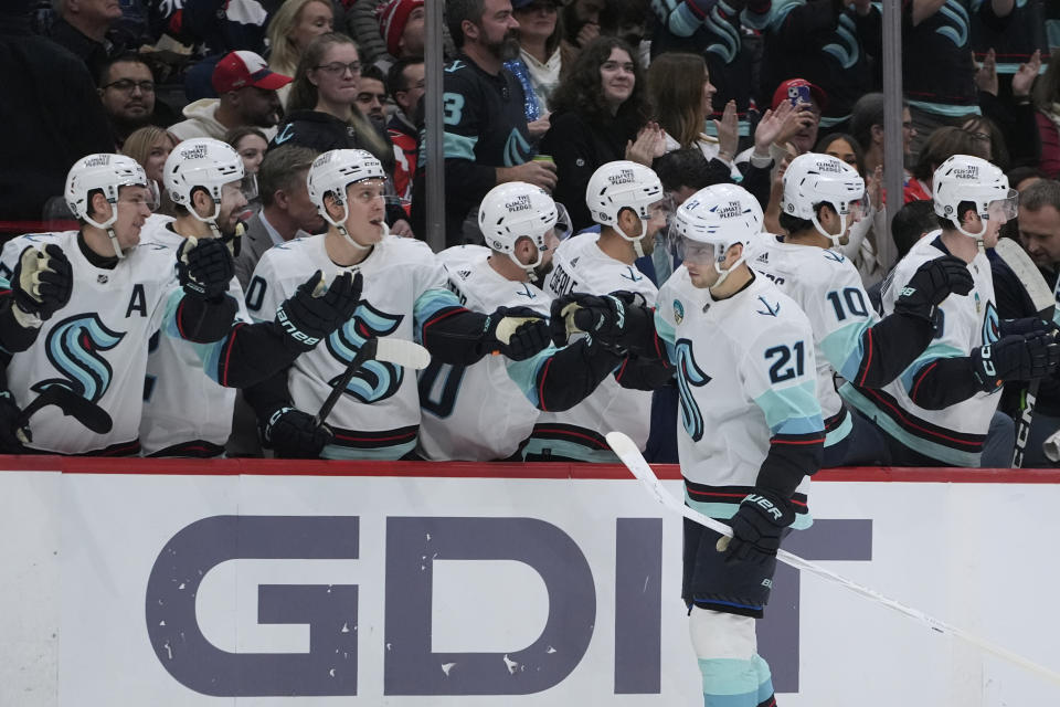 Seattle Kraken center Alex Wennberg (21) is congratulated for his goal against the Washington Capitals during the first period of an NHL hockey game Thursday, Jan. 11, 2024, in Washington. (AP Photo/Manuel Balce Ceneta)
