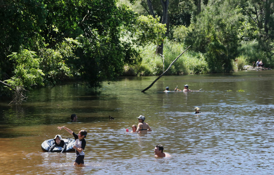 Locals cool off at the Bunya Crossing Reserve in Bunya, North of Brisbane, Tuesday, January 9, 2018. Source: AAP