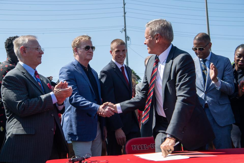 Gov. Bill Lee shakes hands with NFL commissioner Roger Goodell after signing the Smart Heart Act Bill at the Pearl-Cohn High School in Nashville, Tenn., Tuesday, May 21, 2024.
