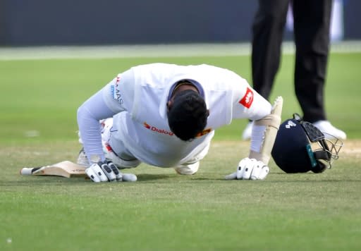 Sri Lanka's batsman Angelo Mathews celebrates reaching his century by performing push-ups in Wellington