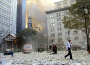 NEW YORK, NY - FILE: People walk away from the area where the World Trade Center buildings collapsed after two airplanes slammed into the twin towers in a suspected terrorist attack September 11, 2001 in New York City. U.S. President Barack Obama announced the death of Osama Bin Laden during a late evening statement to the press May 1, 2011 in the East Room of the White House. Bin Laden has reportedly been killed near Islamabad, Pakistan, almost a decade after the terrorist attacks of September 11, 2001 and his body is in possession of the United States. (Photo by Mario Tama/Getty Images)