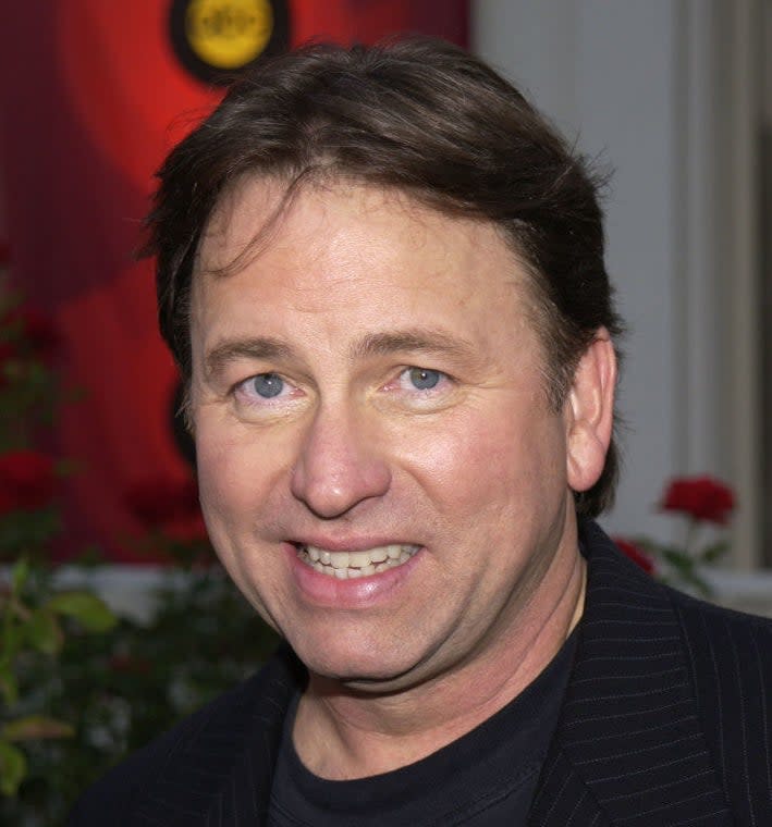 John ritter smiling on a red carpet