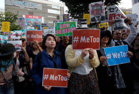 Protesters hold placards during a rally against harassment at Shinjuku shopping and amusement district in Tokyo, Japan, April 28, 2018. REUTERS/Issei Kato