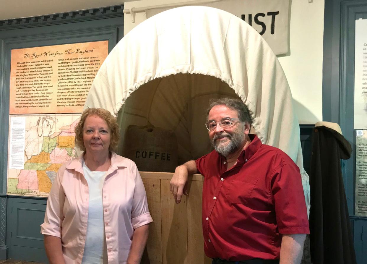 Donna Meyer, executive director of the Delaware County Historical Society, and Meeker Homestead Museum curator Benny Shoults stand next to a replica covered wagon that's part of "The Journey to Delaware County" free exhibit, which can be viewed from 1 to 4 p.m. the first Sunday of each month at the Meeker Homestead Museum, 2690 Stratford Road in Delaware.