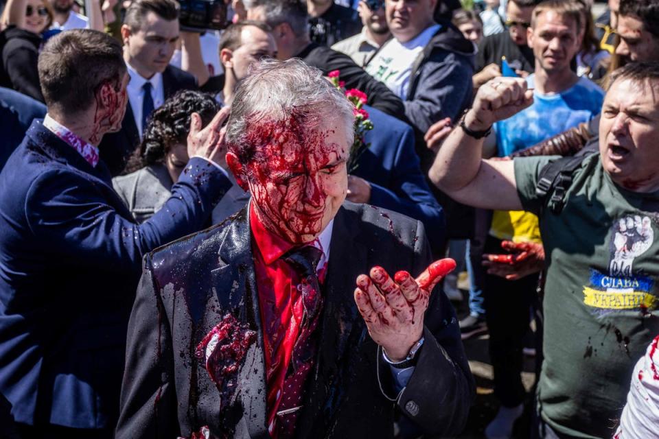 Russian Ambassador to Poland, Sergey Andreev reacts after being covered with red paint prior to a ceremony at the Soviet soldier war mausoleum in Warsaw (AFP/Getty)