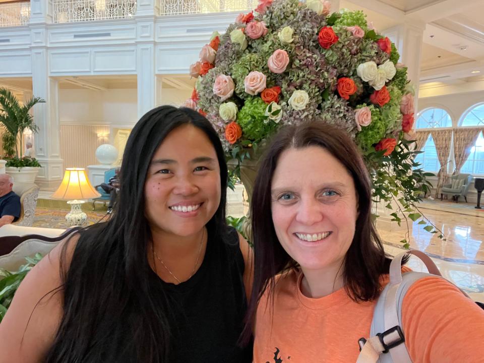 kari and her friend posing for a photo in the lobby of the gran floridian at disney world