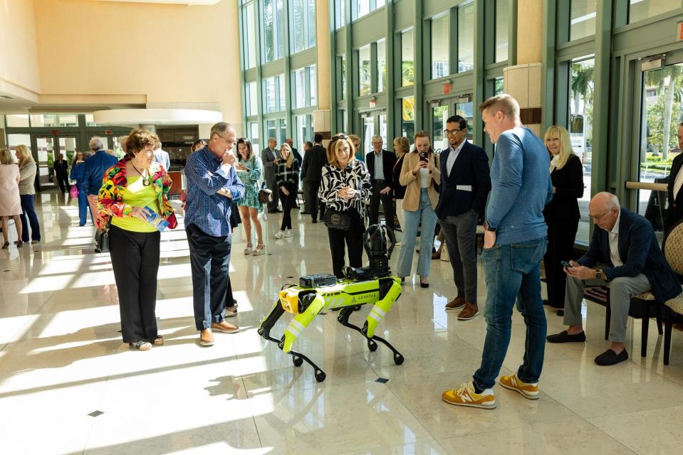 Chris Nielsen, founder and CEO of Palm Beach County-based Levatas, introduces Boston Dynamics' Spot robot to attendees.
