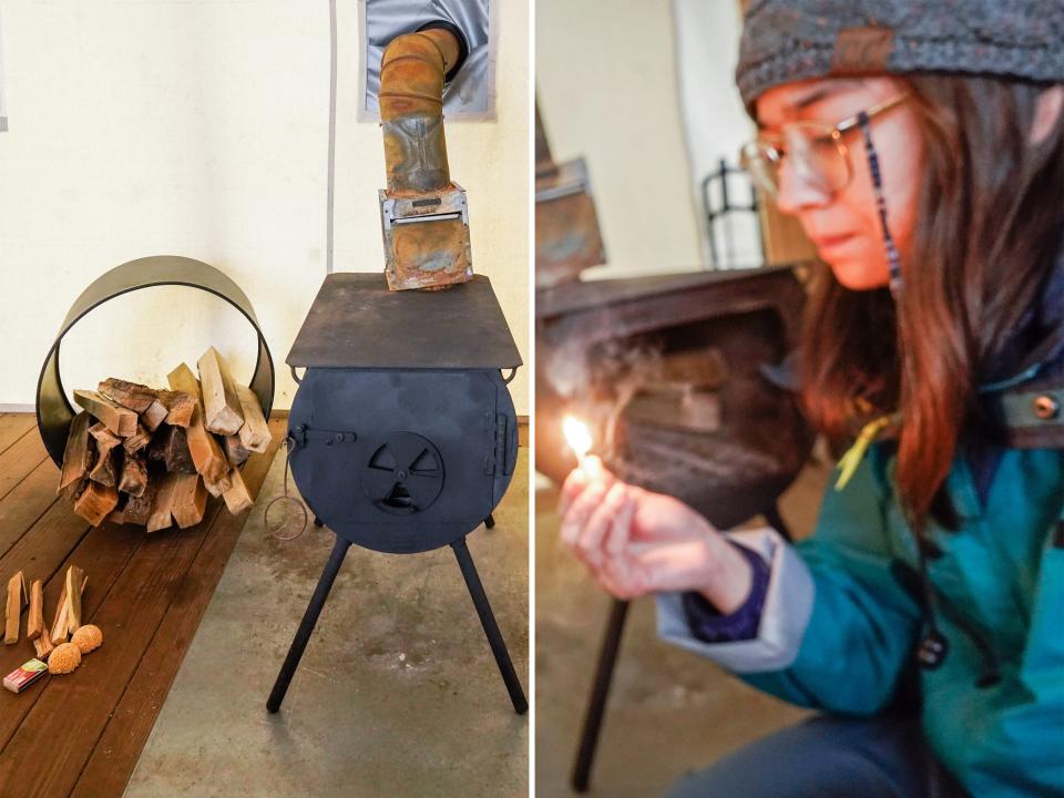 Left: a black wood-fired oven on a stone floor inside a tent with a batch of firewood on the left. Right: The author, wearing glasses and facing left, looks down at an ignited match with the oven behind her.