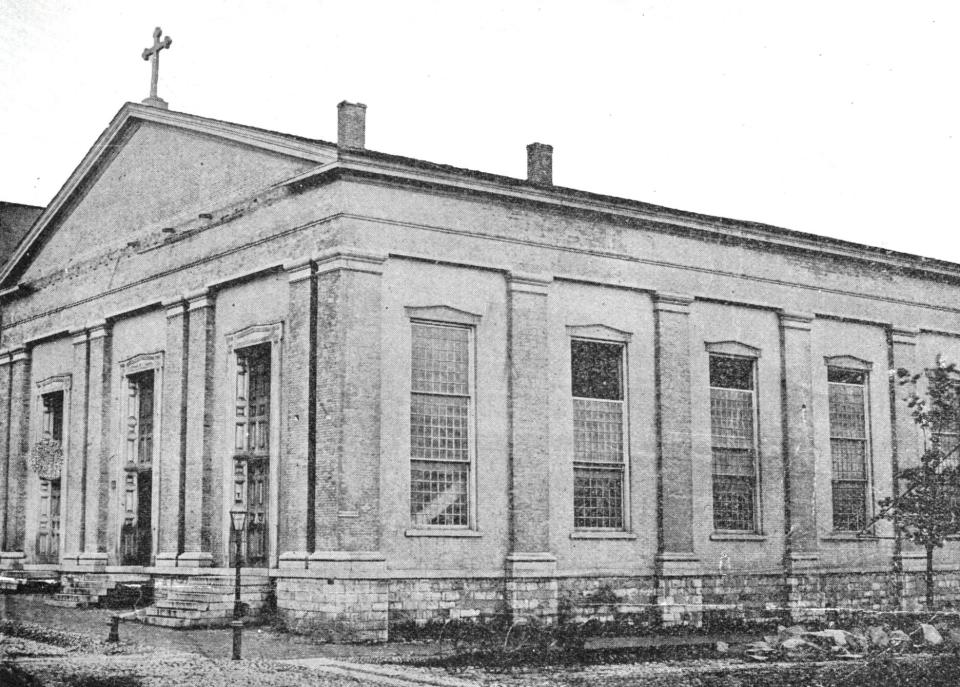 In 1819, Morris S. Miller, a Utica Episcopalian, donated three lots on the southwest corner of John and Bleecker streets to area Catholics who planned to build the first Catholic Church in central and western New York. The first St. John’s Church was completed in 1821. After 14 years of service, it was decided to replace the first church with a second church. It was completed in 1836 and is shown here. Its design was a Greek Revival with a sloping roof—and no tower. The parish continued to grow and by the mid-1860s, it was decided to build a third church. The second church was torn down and while the third church was being built, parishioners worshiped in the old Court House on John Street and in Utica Catholic Academy. The church—its edifice still stands today—was completed in 1872.