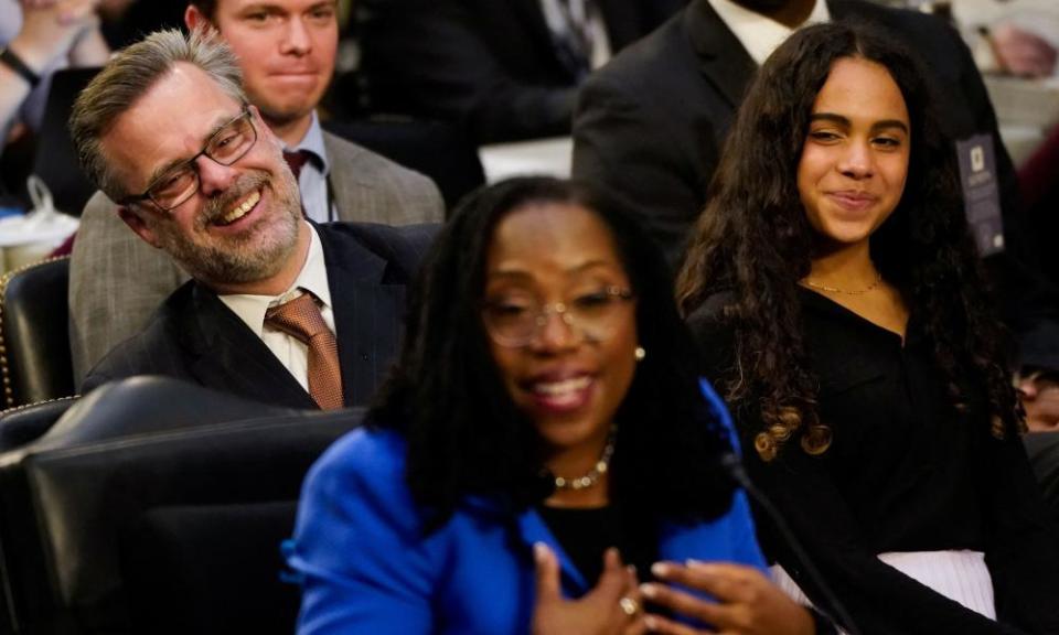 Patrick Jackson, husband of Judge Ketanji Brown Jackson, and their daughter Leila react as the judge answers a question from Senator Alex Padilla.