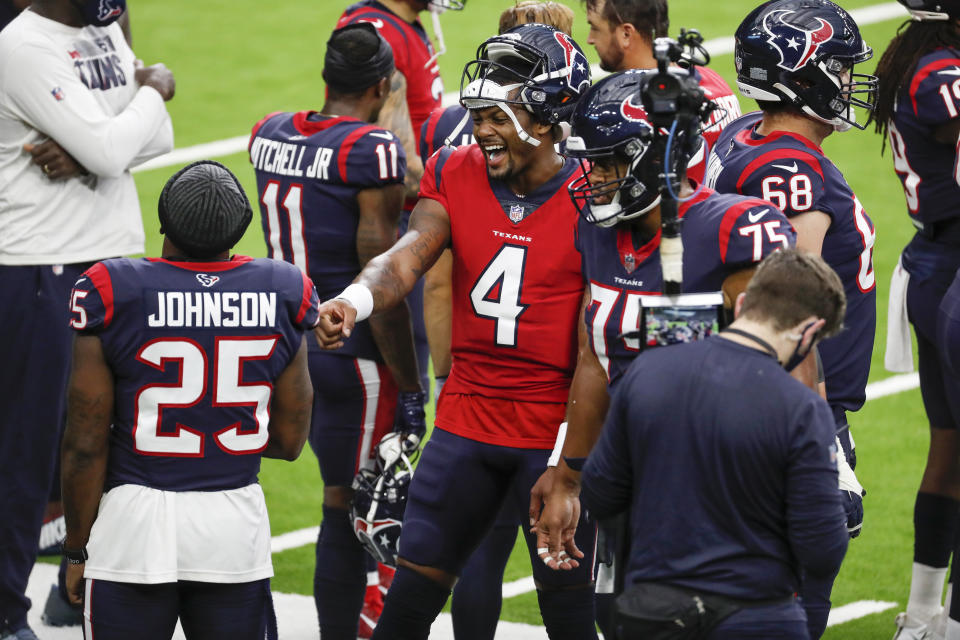 Houston Texans quarterback Deshaun Watson (4) laughs with running back Duke Johnson (25) on the sidelines during NFL football training camp Thursday, Aug. 27, 2020, in Houston. (Brett Coomer/Houston Chronicle via AP, Pool)