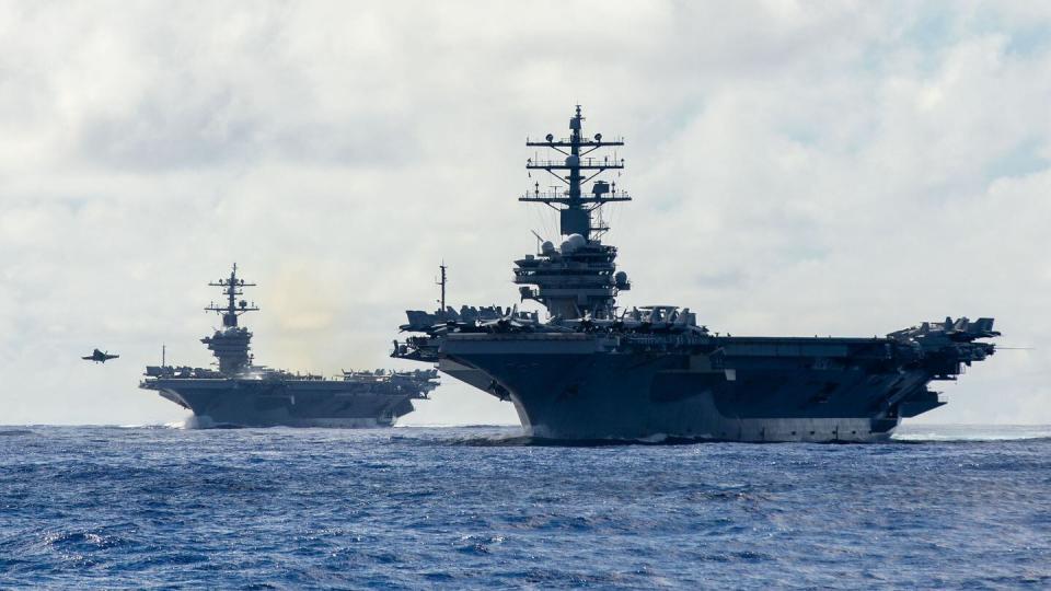 The Nimitz-class aircraft carriers Carl Vinson and Ronald Reagan sail in formation in the Philippine Sea on Nov. 6, 2023. (MC1 Ryre Arciaga/U.S. Navy)