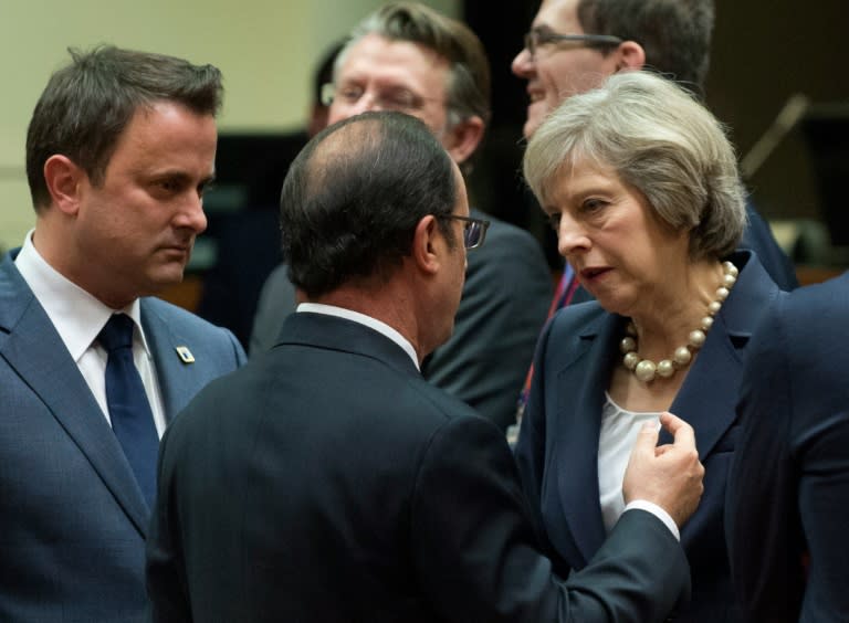 France's President Francois Hollande (C) speaks with Britain's Prime minister Theresa May as Luxembourg's Prime minister Xavier Bettel looks on, during an EU leaders summit on October 20, 2016, at the European Council in Brussels