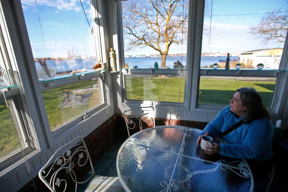 Anita Regan enjoys a cup of coffee looking out into New Bedford harbor from the former Westview Mansion at the intersection of Main Street and Church Street in Fairhaven which she has converted into a home care facility.
(Credit: PETER PEREIRA/The Standard-Times)