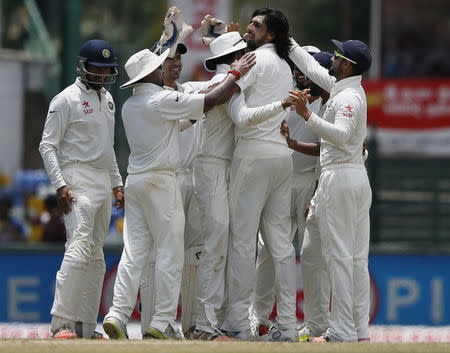 India's Ishant Sharma (C) celebrates with his teammates after taking the wicket of Sri Lanka's Lahiru Thirimanne (not pictured) during the third day of their third and final test cricket match in Colombo , August 30, 2015. REUTERS/Dinuka Liyanawatte