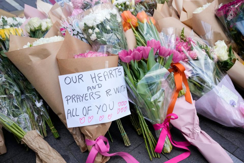 A note is left with flower tributes near the scene at Bondi Junction in Sydney (Rick Rycroft/AP) (AP)