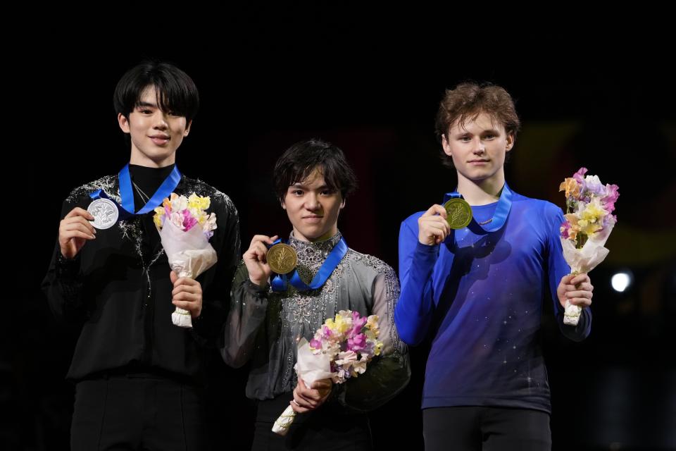 Shoma Uno of Japan, center, with his gold medal, Cha Junhwan of South Korea, left, with his silver medal, and Ilia Malinin of the U.S., with his bronze medal, pose for a photo during the award ceremony for the men's free skating in the World Figure Skating Championships in Saitama, north of Tokyo, Saturday, March 25, 2023. (AP Photo/Hiro Komae)