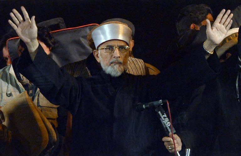 Pakistani religious leader Tahir-ul Qadri greets supporters at a protest rally in Islamabad, on January 15, 2013. The cleric has urged thousands of protesters massed in Islamabad to camp out for another day, defiant after police fired tear gas and the government ignored his ultimatum to disband parliament