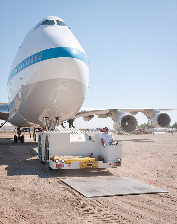 Aircraft tug driver Don Bailes tows SCA 911 onto steel plates after its final journey from NASA Armstrong's Palmdale facility to the nearby Joe Davies Heritage Airpark. The aircraft will be on permanent display at the historic outdoor museum fr