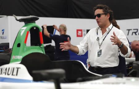 Alejandro Agag, Formula E CEO, gestures next to Michela Cerruti's Formula E car in the box during an interview with Reuters ahead of round four of the Formula E championship in Buenos Aires, January 8, 2015. REUTERS/Marcos Brindicci