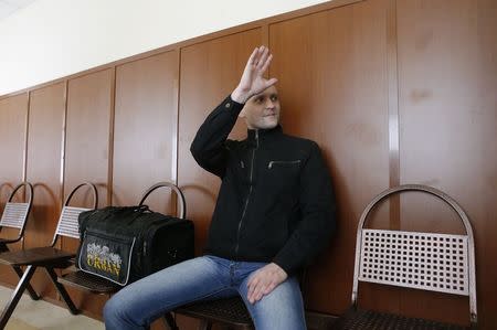 Opposition leader Sergei Udaltsov gestures as he waits to attend a court hearing in Moscow July 24, 2014. REUTERS/Maxim Shemetov