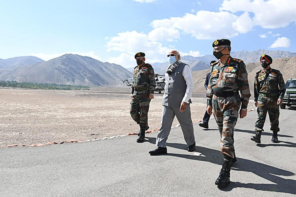 In this handout photograph taken on July 3, 2020 and released by the Indian Press Information Bureau (PIB), India's Prime Minister Narendra Modi (C) walks with military commanders as he arrives in Leh, the joint capital of the union territory of Ladakh. - Prime Minister Narendra Modi made a surprise visit to India's northern frontier region with China on July 3 in his first trip to the area since a deadly border clash last month. (Photo by Handout / PIB / AFP)