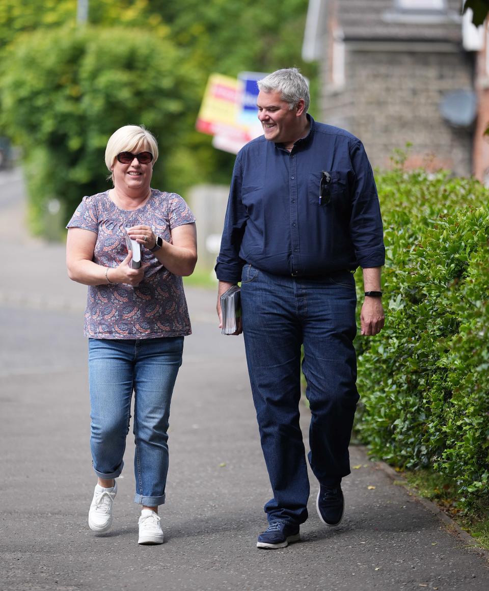 DUP leader Gavin Robinson canvasses for votes with a party worker in East Belfast (Niall Carson/PA)