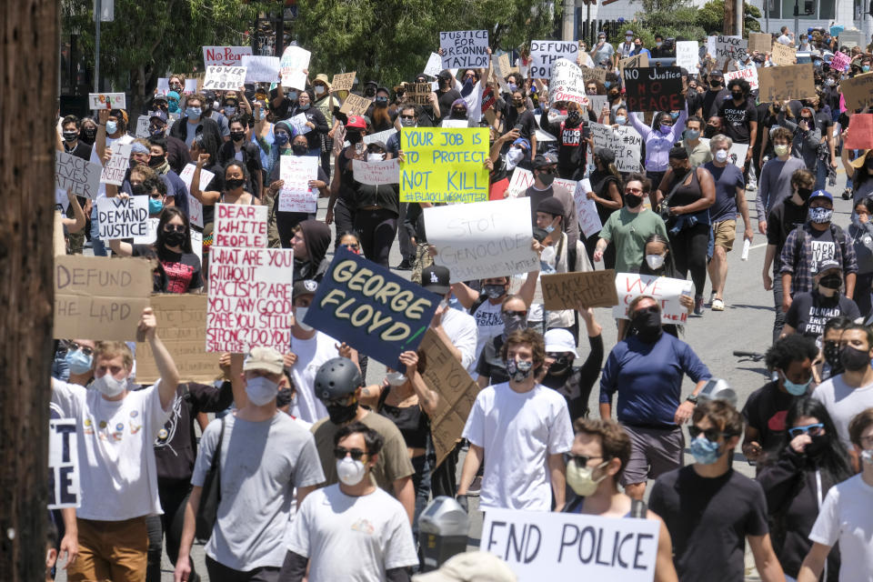 Protesters march on a street during a protest over the death of George Floyd, who died on Memorial Day after being taken into custody by Minneapolis police, in Los Angeles, Saturday, May 30, 2020. Floyd died after a police officer pressed his knee into his neck for several minutes even after he stopped moving and pleading for air. (AP Photo/Ringo H.W. Chiu)