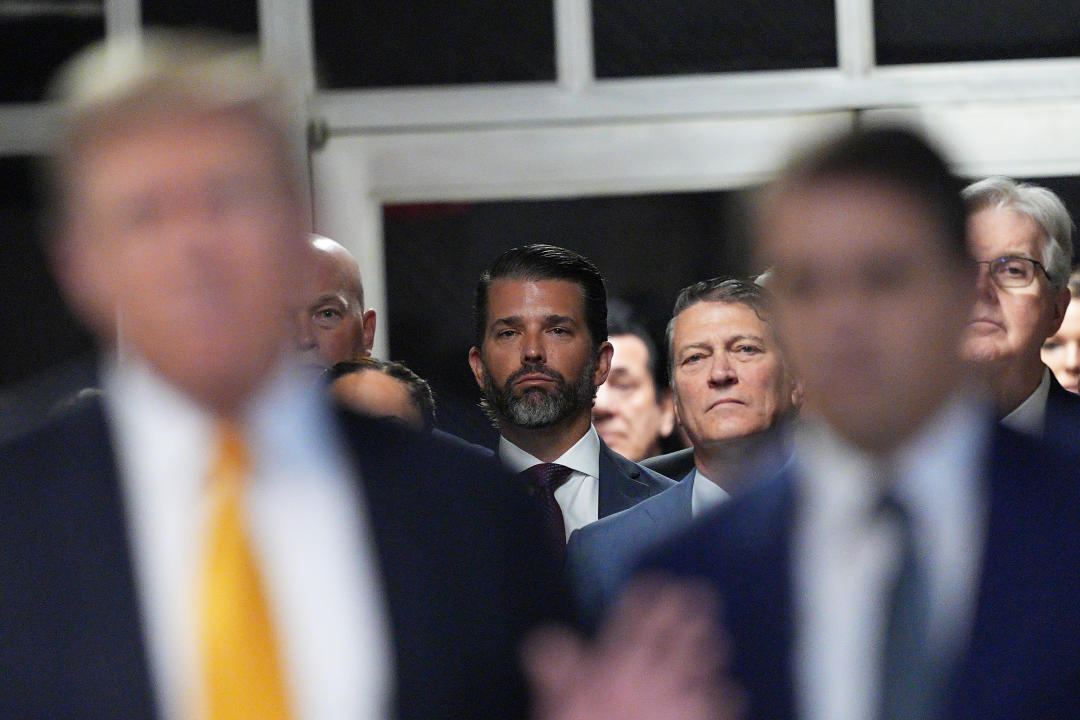 Donald Trump Jr. watches as his father speaks to reporters after arriving at Manhattan criminal court on Tuesday. (Curtis Means/Pool via Getty Images)