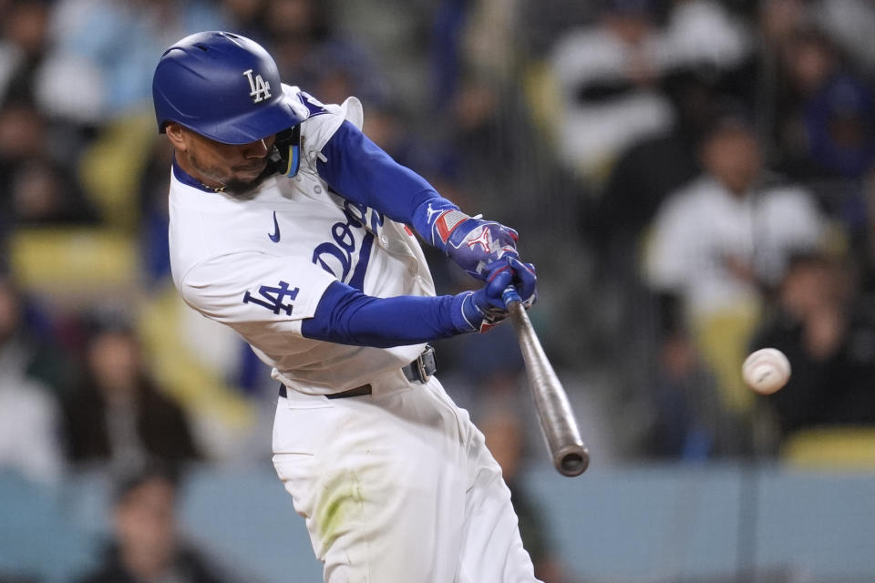 Los Angeles Dodgers' Mookie Betts connects for a single against the San Diego Padres during the third inning of a baseball game Saturday, April 13, 2024, in Los Angeles. (AP Photo/Marcio Jose Sanchez)