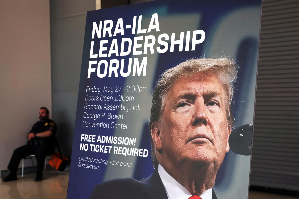 A sign showing former U.S. President Donald Trump, who will be speaking at the NRA-ILA Leadership Forum, stands posted inside the National Rifle Association (NRA) annual convention at the George R. Brown Convention Center in Houston, Texas, U.S., May 26, 2022. REUTERS/Shannon Stapleton