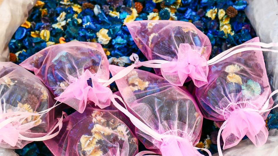 Pink sachet bags containing homemade potpourri in a small pile