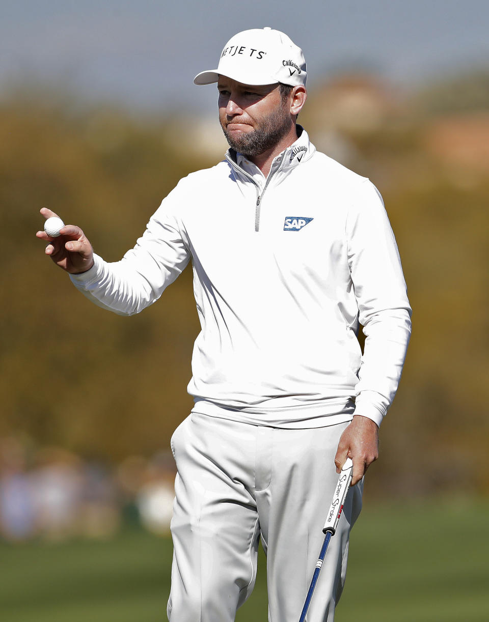 Branden Grace waves after making his birdie putt on the 15th green during the second round of the Phoenix Open PGA golf tournament, Friday, Feb. 1, 2019, in Scottsdale, Ariz. (AP Photo/Matt York)