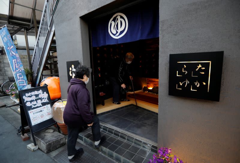 People enter a Japanese public bathhouse, or sento, in Tokyo