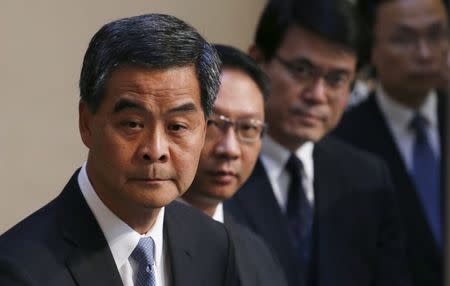 Hong Kong Chief Executive Leung Chun-ying (L) and officials listen to a question during a news conference in Hong Kong, China June 18, 2015. REUTERS/Bobby Yip