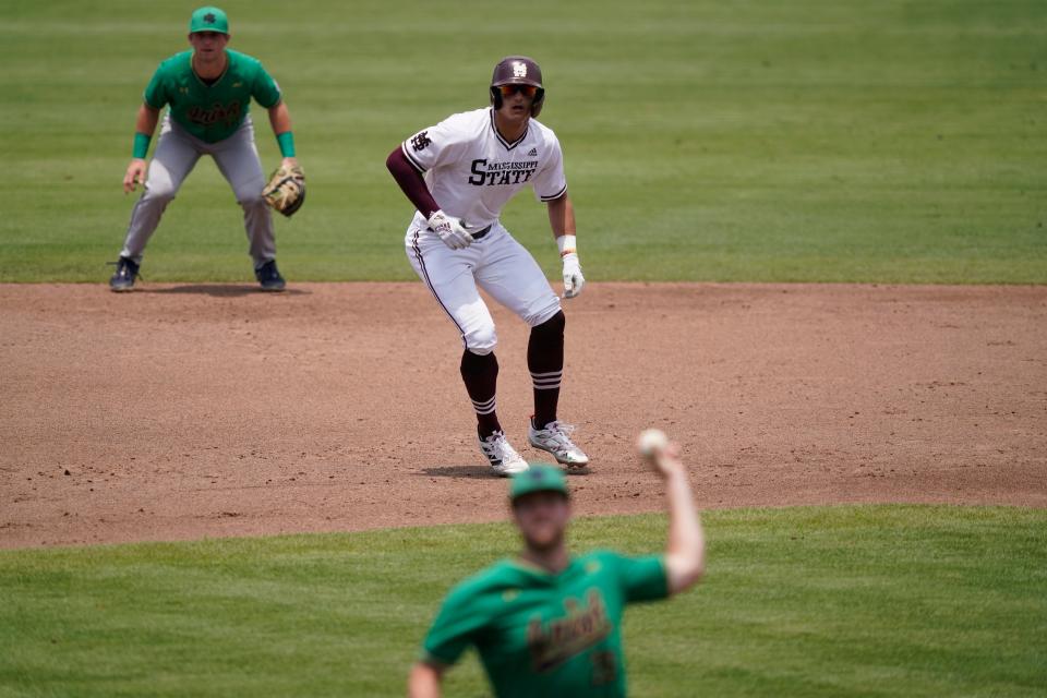 Mississippi State's Brad Cumbest readies to run towards third base as Notre Dame pitcher John M. Bertrand throws during an NCAA college baseball super regional game, Saturday, June 12, 2021, in Starkville, Miss. (AP Photo/Rogelio V. Solis)