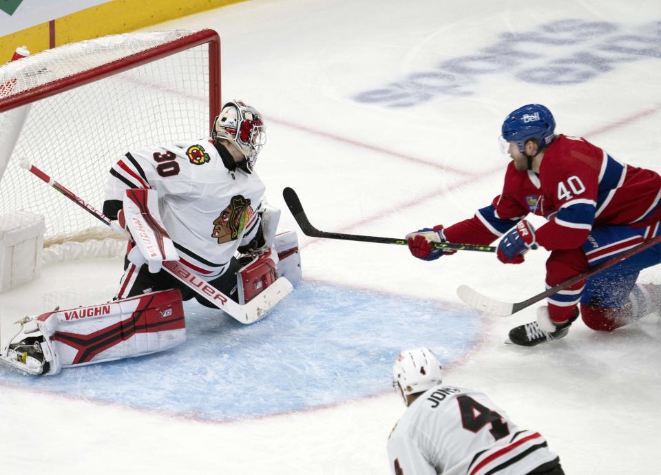 Montreal Canadiens Joel Armia (40) scores on Chicago Blackhawks goaltender Jaxson Stauber (30) during the third period of an NHL hockey game, Tuesday, Feb.14, 2023 in Montreal. (Ryan Remiorz/The Canadian Press via AP)